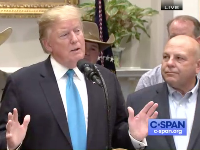 President Donal Trump speaks at an event with farmers last month as American Farm Bureau President Zippy Duvall looks on.  